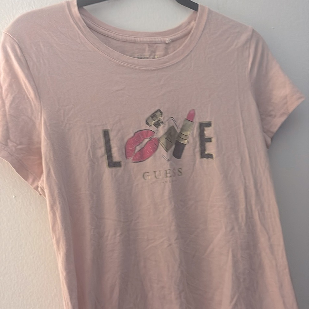 T-shirt features a "LOVE" graphic on the front that includes lip and perfume .